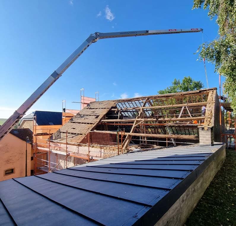 Blang & Lauterbach roofer inspecting and repairing a tiled roof covering